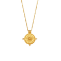 A gold pendant necklace featuring a circular sunburst compass design on a matching chain, shown against a gray checkered background.